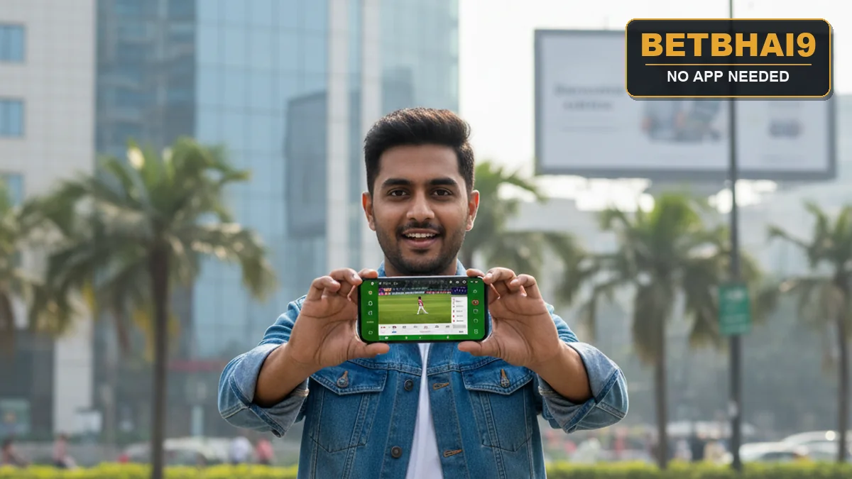 A young person holding a smartphone showing the Betbhai9 mobile betting website in full screen